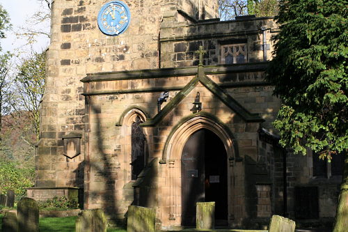 The porch of the Church of St. Lawrence, Eyam, Derbyshire in early spring sunshine